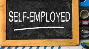Chalkboard displaying the words "Self-employed"