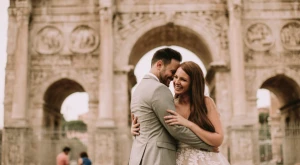 Smiling couple in front of the Italian flag celebrating their citizenship
