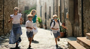 Children running and playing along a narrow street