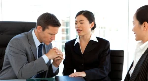 Three workers take part in a meeting