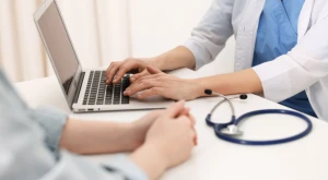 Doctor writing a diagnosis during a medical consultation.
