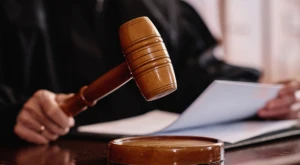 Judge holding a gavel in a courtroom, symbolizing judicial review of citizenship appeals