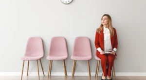 Person sitting in a waiting room, looking ahead.