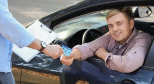 Driver behind the wheel of a car, focused on the road.