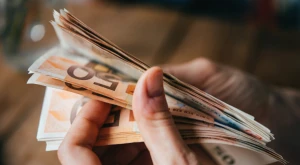 A person counting euro banknotes by hand