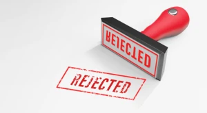 A close-up of a stamp marked 'REJECTED' in red ink