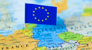 European Union flag placed over a map of Europe, symbolizing intra-EU mobility under the EU ICT scheme for highly qualified workers