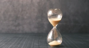 Hourglass with sand flowing, symbolizing waiting time
